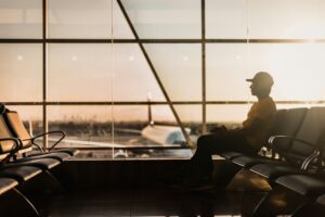 Picture of a gentleman sitting in the airport terminal waiting for a flight looking nervous about what he is carrying on the flight. Contact City Leaves today for more information (609) 288-8574.